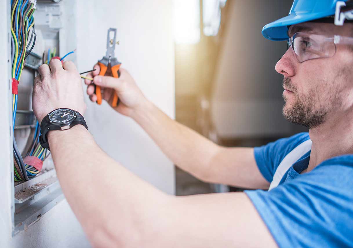 electrician adjusting electrical panel in home