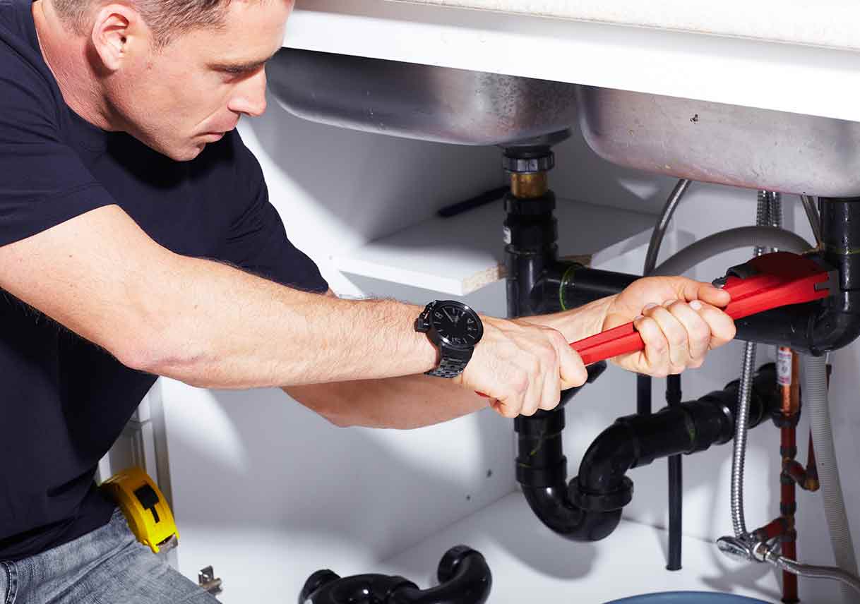 plumber fixing kitchen sink