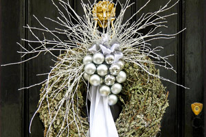 Christmas wreath with silver pendants on door