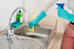 Woman cleaning the kitchen sink