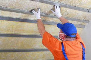 contractor installing wool attic insulation