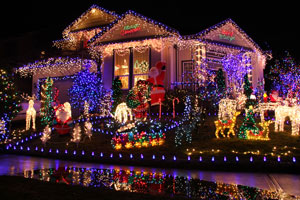 house at night lavishly decorated with Christmas lights and figurines