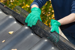 man working on gutters