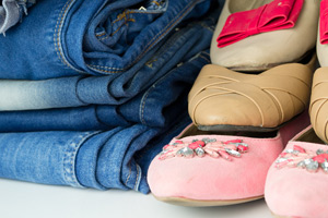 stack of jeans next to pile of shoes